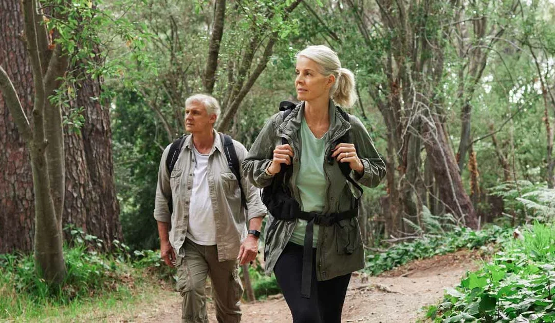 Two hikers enjoy the benefits of hiking without glasses or contacts after cataract surgery.